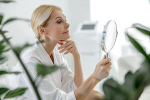 a woman looking at a mirror