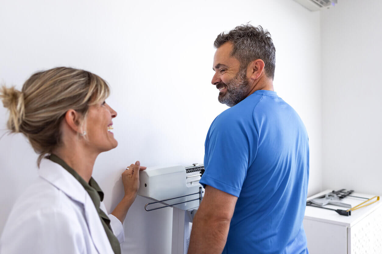 Man weighing his weight at weight loss clinic