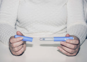 Woman holding an Wegovy injection for weight loss