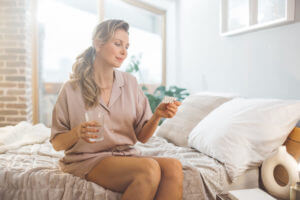 A woman is taking testosterone supplements as part of her hormone replacement therapy for menopause.