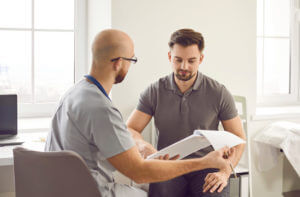 Young man patient visiting a doctor at the office for testosterone therapy for men.