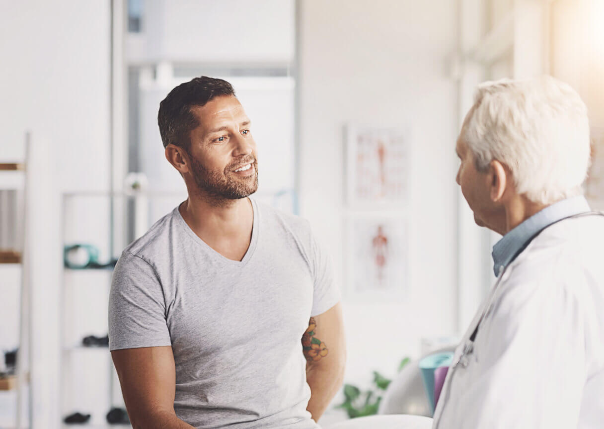 A patient discussing with doctor about how Testosterone therapy can help men with low testosterone (low T).